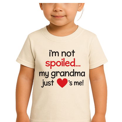 Child wearing a t-shirt with text 'i'm not spoiled... my grandma just ❤️ s me!' on a white background